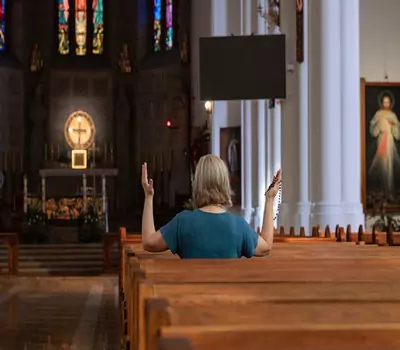 A woman praying inside a church in Poland.