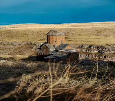 Rustic Armenian church in serene Landscape setting.