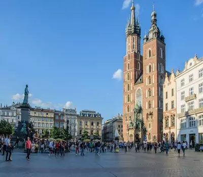 People in walking at the Krakow Market Square in Poland.