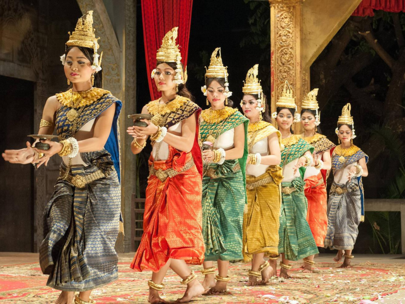 Traditional Cambodian dancers in colorful costumes performing on stage 