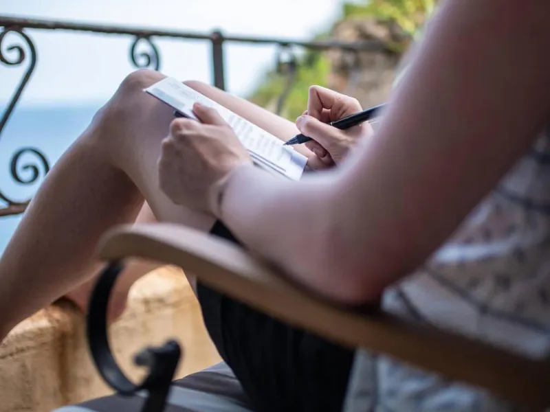 Woman writing on vacation