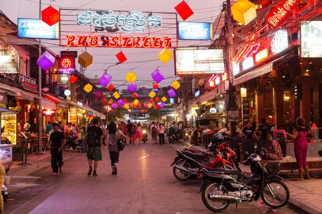 Bustling Pub Street with colorful lights and signs 