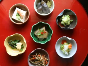 An assortment of Japanese Kaiseki dishes in small colorful bowls