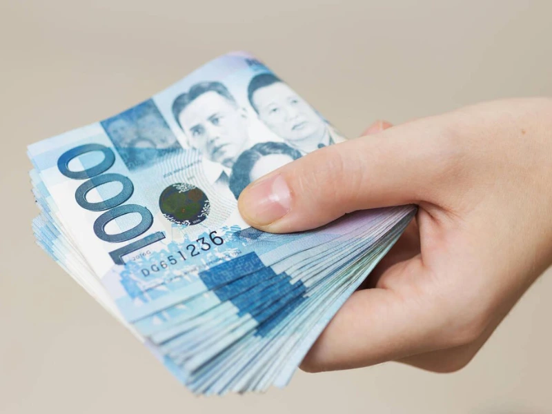 man holding a wad of cash