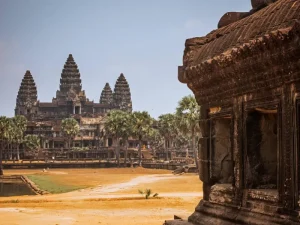 Close view of Angkor Wat temple complex with its intricate architecture and lush palm trees