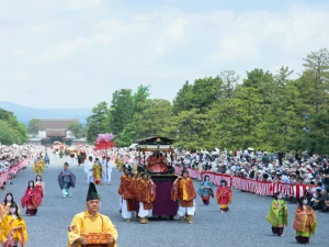 Procession of participants in elegant traditional Heian-era costumes during the Aoi Matsuri festival in Kyoto.