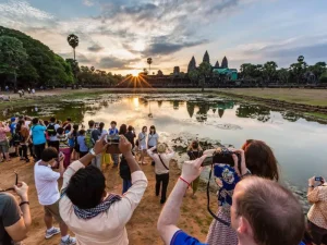 Tourists gathering at Angkor Wat to capture the beautiful sunrise view of the ancient temple