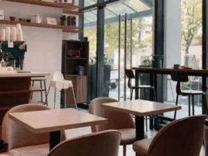 Cozy interior of Habitual Coffee with wooden tables and chairs