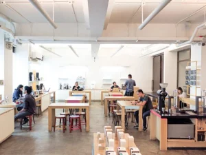 Spacious, minimalist coffee shop interior with customers working and chatting