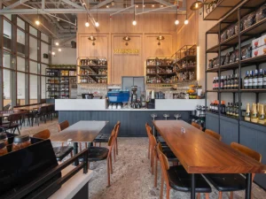Refinery café interior featuring wooden decor and a coffee bar.