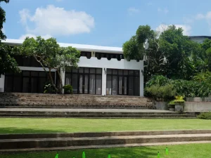 Expansive lawn with modern white villa at Hacienda Isabella