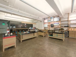Open coffee brewing area with modern equipment and wooden countertops.