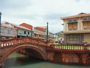 An elegant stone bridge connects historic houses over water