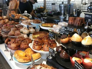 Assorted cakes, croissants, and pastries displayed at bakery counter