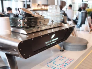 Espresso machine with Toby’s Estate logo at café counter.