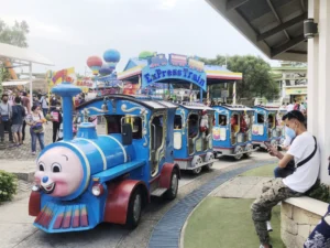 Sky Ranch Express Train ride with passengers in amusement park