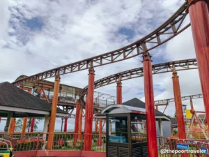 Sky Ranch roller coaster with red pillars under cloudy sky
