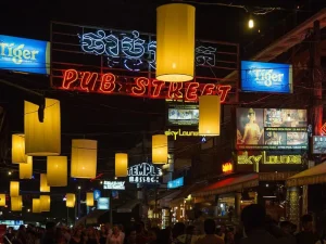 Pub Street - Travelpreneur A lively view of Pub Street with neon signs and hanging lanterns