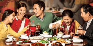 cp1d - Travelpreneur a family enjoying dinner on a restaurant with a table full of filipino dishes like adobo and sinigang