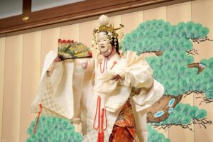 A stage performance at Gion Corner where the performer is captured dancing on stage