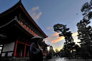 Myoshin-ji Temple at dusk with few visitors walking around temple grounds