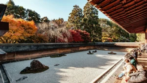 Ryoan-ji’s Zen Rock Garden white people sitting on the main balcony looking at the garden