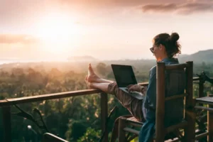 a woman working on a tropical balcony