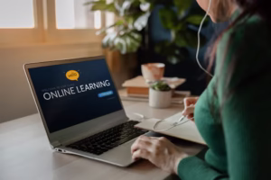 32 learning - Travelpreneur a woman looking at the laptop screen which states online learning