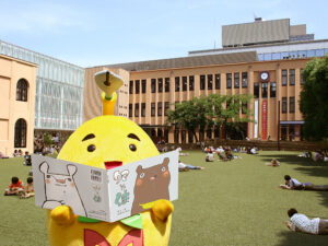 8 kyoto museum - Travelpreneur Kyoto International Manga Museum mascot in front og the building