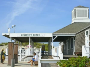 Cooper’s Beach entrance with people enjoying sunny beach weather
