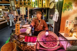 Kyoto-Japan-Nishiki-market 6 - Travelpreneur a vendor happily providing great customer service