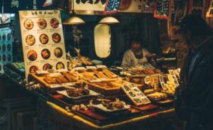 Nishiki-market-Feature-photo-1200x350-Food-stalls-526x320 - Travelpreneur a cinematic photo of a food stall at nishiki market
