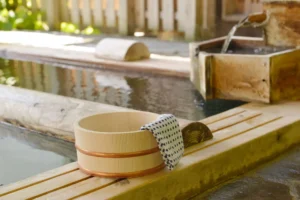 Onsen pool and wooden bowl with bath materials