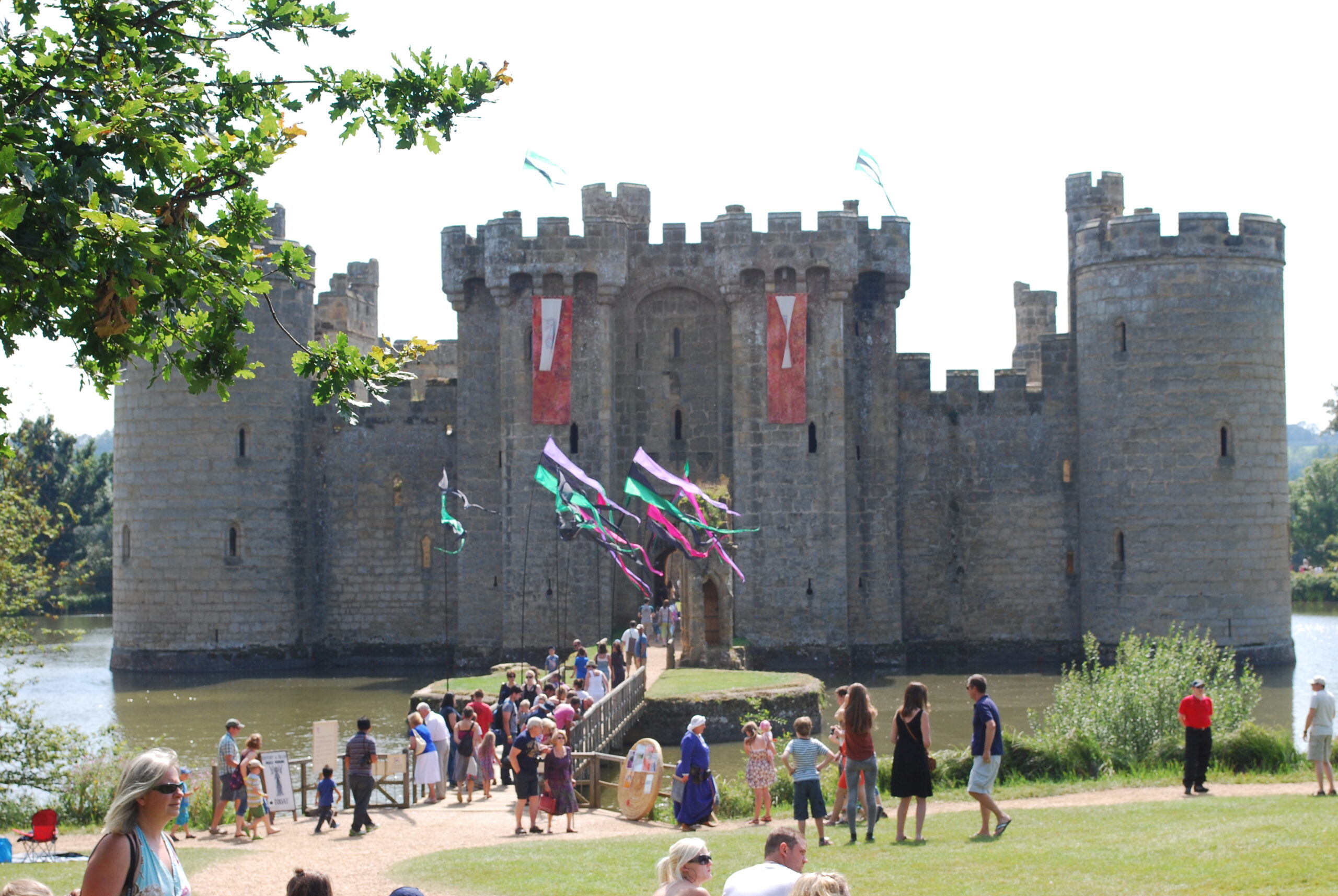 Bodiam Castle ground filled with tourist going in and out the gatehouse