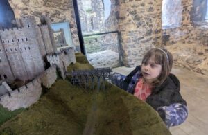 Rochester Castle exhibit with a beautiful child looking at the miniature model of the castle