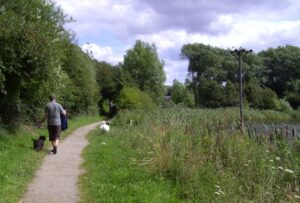 A man walking along the Carr Vale path