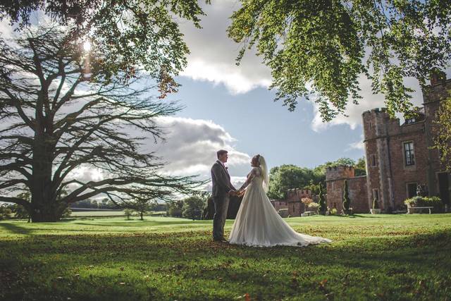 Shrewsbury Castle Wedding Photography of a groom and bride with the castle as their background